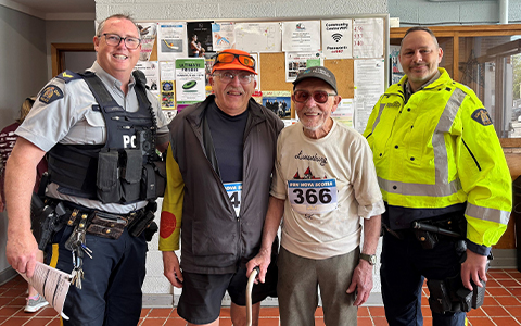 Deux agents de la GRC posent pour une photo avec deux participants à la course.