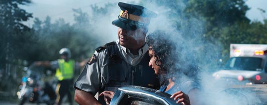 Officer helping woman.