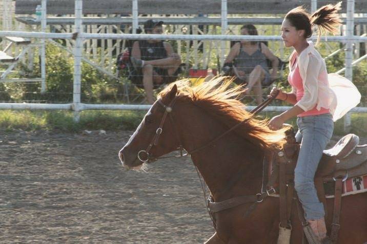 A young person riding on a horse.