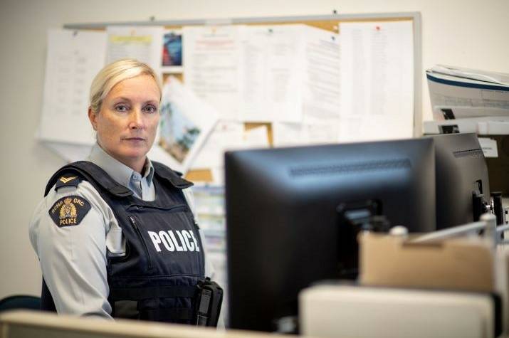 Police officer staring into the camera.