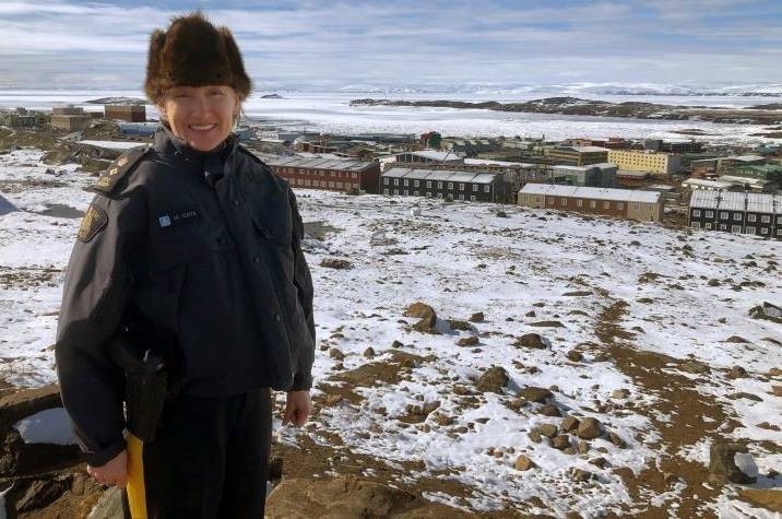 RCMP officer standing in fron of a community