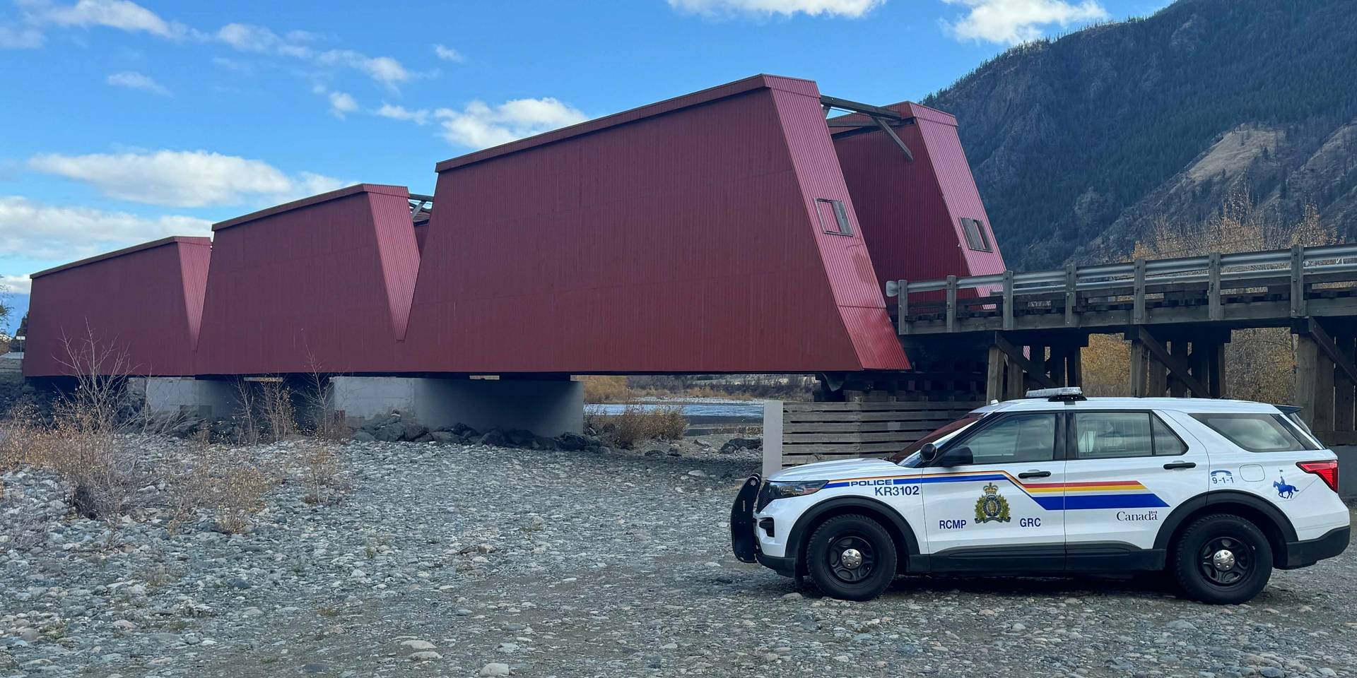the historic Red Bridge with a Keremeos RCMP police car