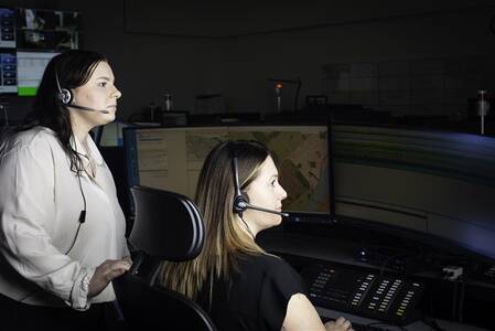 Photo of two female 9-1-1 Police Dispatchers working in the Operations Communications Centre.