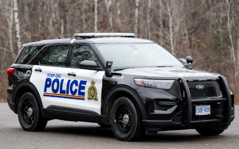 An RCMP police vehicle outside.