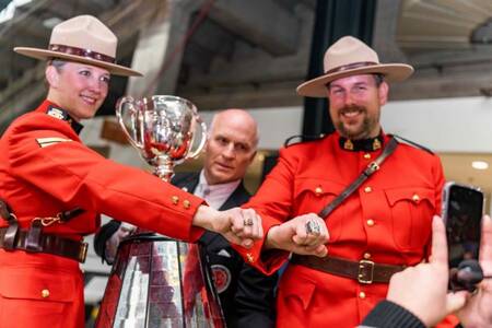 Cpl. Kristy Powell, former BC Lion Cheerleader and Cst. Adam Baboulas, who played in the CFL were thrilled to carry the Grey Cup during the game in Vancouver last November.
