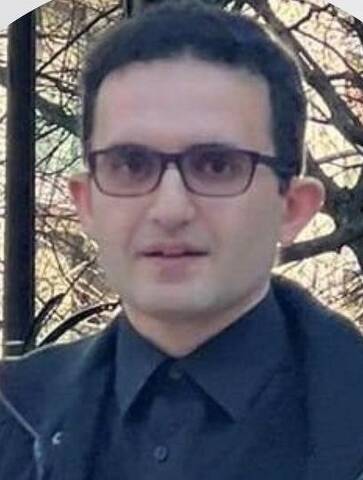 man with dark hair and glasses