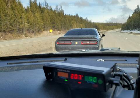 A black Dodge Challenger stopped in the passing lane on Highway 97C near Elkhart, BC
