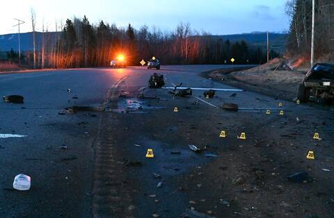 Cones, debris, and emergency vehicles at the scene of a double-fatal crash on Highway 97S in Chetwynd, BC