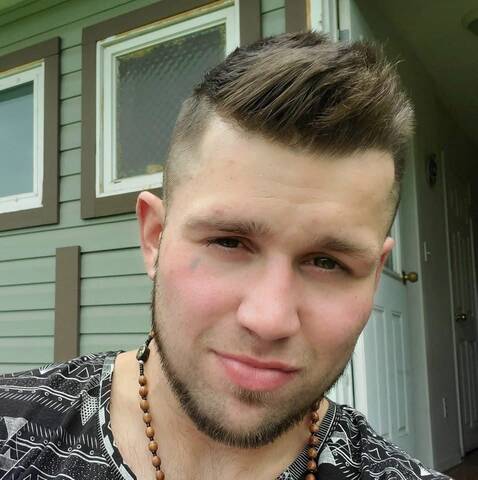 a man with a goatee and short brown hair.