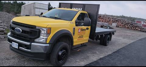 A yellow delivery truck with a Home Hardware logo on the door.