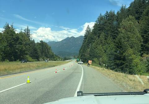 Police block traffic lanes using cones on Highway #1 while they investigate a fatal collision near Hope