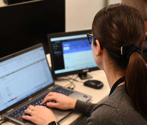 An RCMP analyst works on her laptop researching men seeking sexual services from undercover officers.