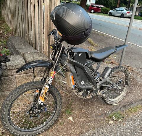 photo of e-dirt bike at side of road