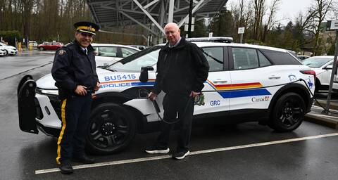 Burnaby RCMP Officer in Charge Chief Superintendent Bill Parmar and Burnaby Mayor Mike Hurley pose with the detachment’s new electric patrol vehicle, which is being tested as part of a pilot project.