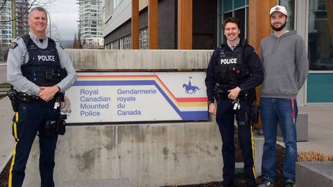 An image of a police officer standing alongside his sons