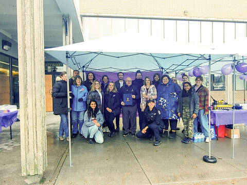 Group of people standing with the signed proclamation document