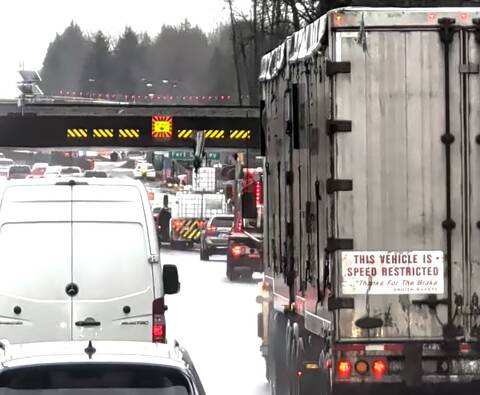 A boom on the load of the white flatdeck truck in the centre of this photo struck the CP Rail overpass over Highway #1 in Langley