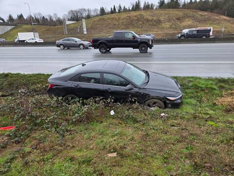 A Hyundai sedan buried in mud after a new driver lost control on Highway #1