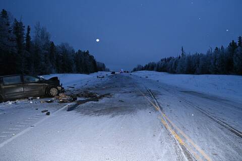 The aftermath of the collision on Highway #97 North near Wonowon with the black Dodge Caravan in the foreground and the green F350 and police vehicles in the background