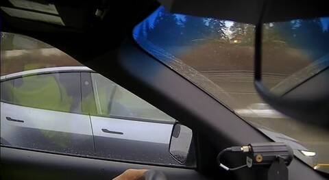 A screenshot of police video that showed a driver who appeared to be asleep at the wheel of an electric vehicle during rush-hour traffic