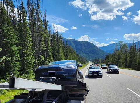 This Tesla, being loaded onto a tow truck as a BC Highway Patrol vehicle supervises the impound, contained a family going 148 km/h in a 90 zone in Yoho National Park