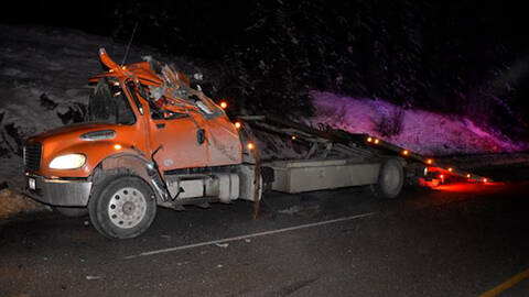 A destroyed tow truck after it was struck by a tractor trailer that failed to Slow Down and Move Over