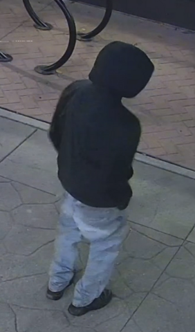 Man wearing black hoody and blue jeans