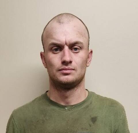 Male with buzz cut and green shirt