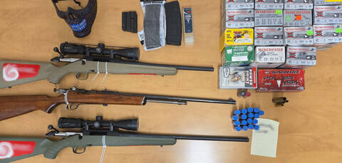 Three firearms, ammunition, and a mask. | Trois armes à feu, des munitions et un masque.