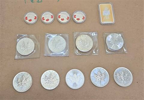 Photo of silver coins and silver bar seized by police.