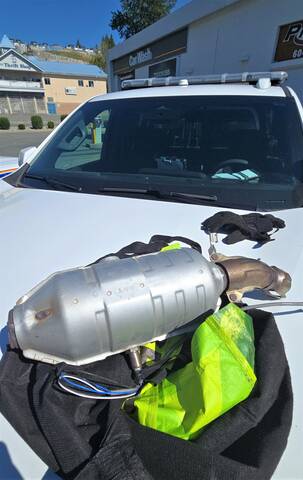 Photo of a recovered catalytic converter on the hood of a police car.