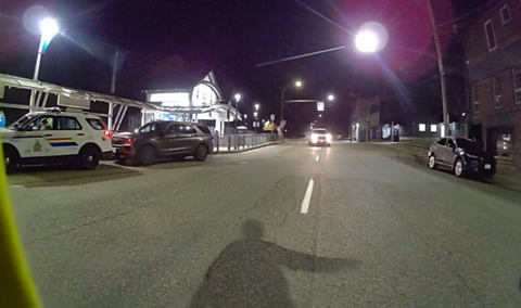 Photo showing an officer’s shadow as he directs a vehicle to pull over along North Railway Avenue.
