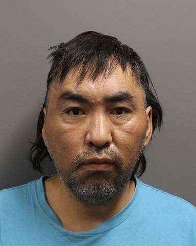 Ralph Achla with short black hair wearing a light blue crewneck t-shirt