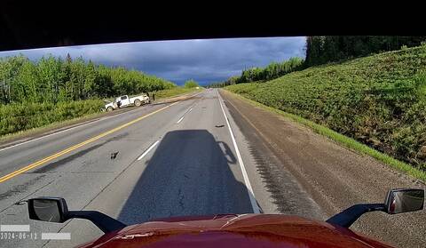 Two pickups at the side of the Alaska Highway after a fatal collision in 2024