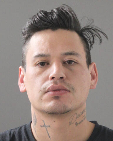 A male with short brown hair, brown eyes, and neck tattoos.