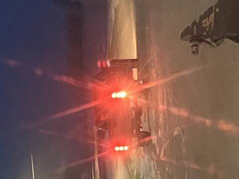 A red GMC or Chevrolet half-ton pickup truck with a silver rear bumper and black mudflaps. // Une camionnette rouge GMC ou Chevrolet d'une demi-tonne avec un pare-chocs arrière argenté et des garde-boue noirs.