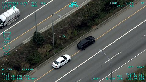 A BC Highway Patrol unmarked “ghost car” stopped behind a black Cadillac on Highway #1 in Surrey